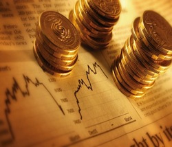 coins sitting on top of stocks