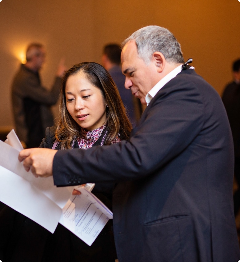 Conference Attendees examining papers