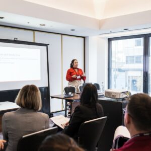 KG-Anna-Allen-146 Woman presenting to audience in the office