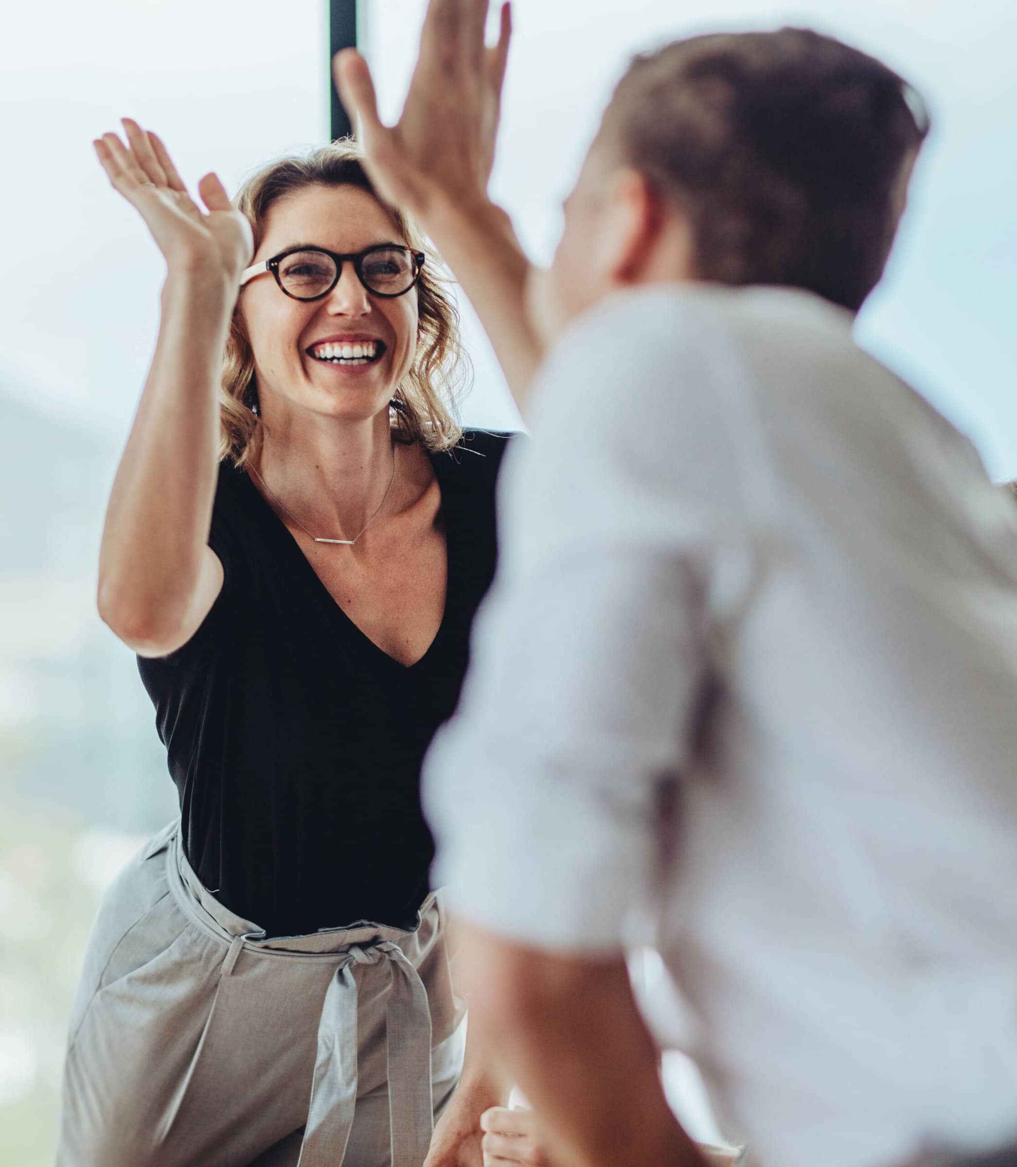 Office workers happy doing a high five