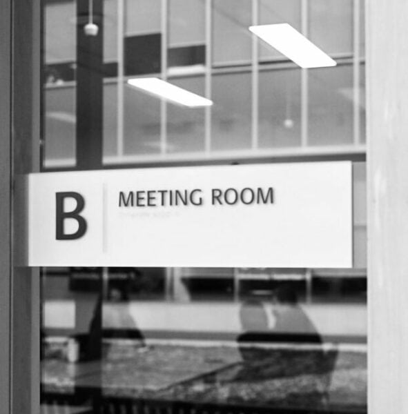 a black and white photo of a meeting room