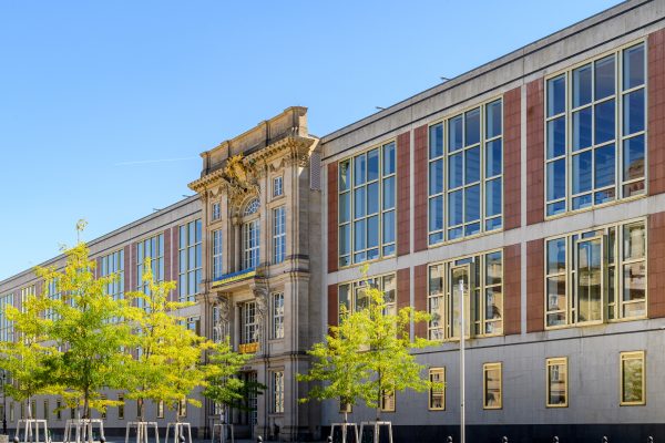 ESMT Berlin campus in with green trees and blue skies.